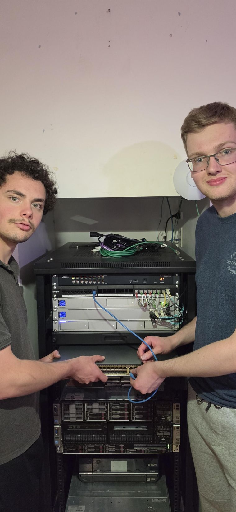 Jaylem and Ben working together on a server rack